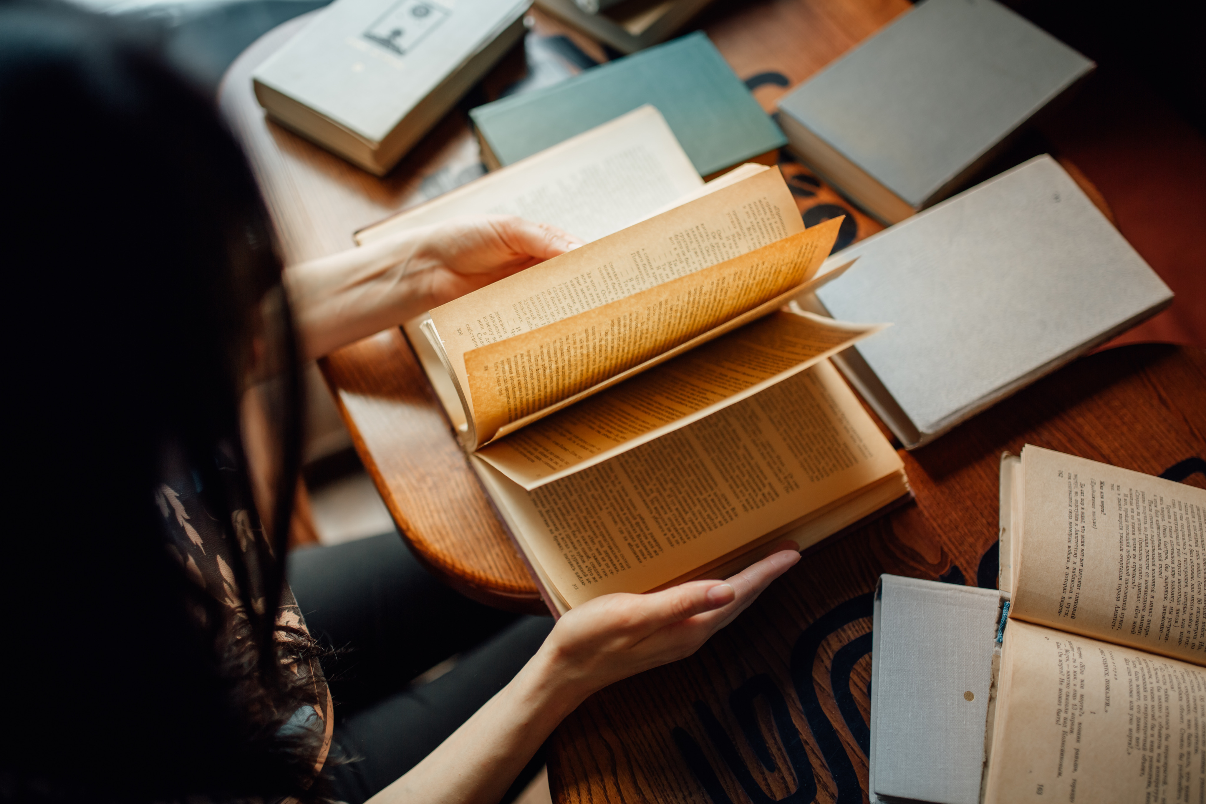 Hands turning pages of a published book